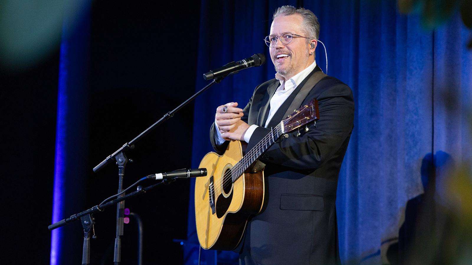 Musician with guitar performing on stage